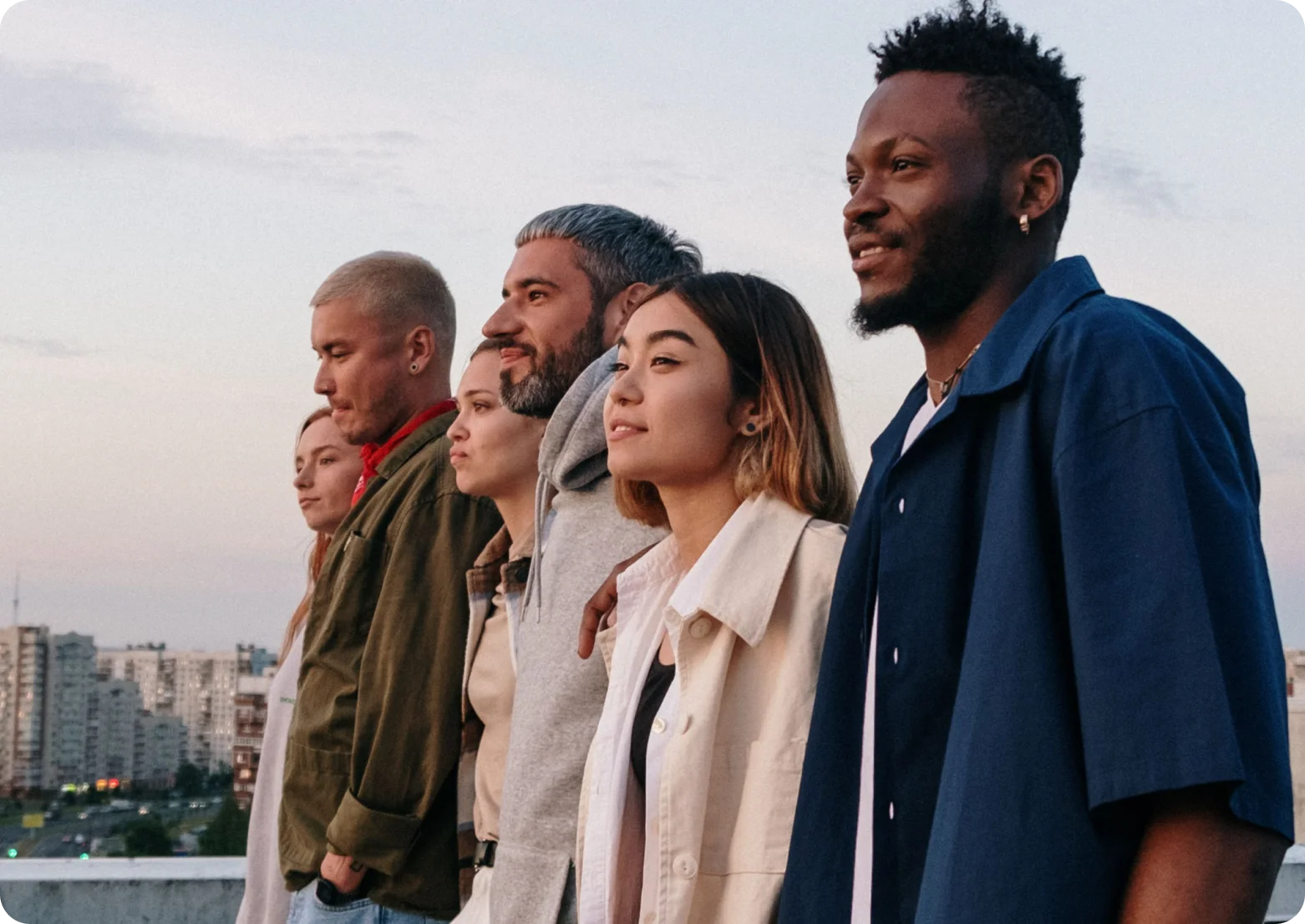 Developers looking out over a city at sunset